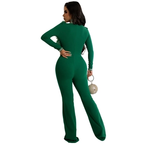 Detail of dark green jumpsuit with feather trim on sleeves and slim fit back design