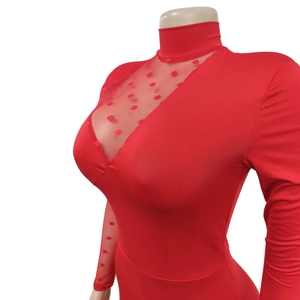 Detail of red jumpsuit featuring polka dot mesh sheer panels on high neck and long sleeves