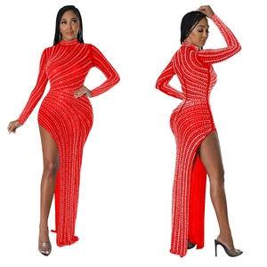 Detail view of red high-neck gown with silver rhinestones in a wave pattern and high slit