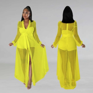 Detail view of yellow mesh long sleeve jumpsuit with waist belt and sheer mesh fabric texture