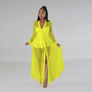 Detail of elegant bright yellow sheer mesh maxi dress with deep V-neck and waist belt