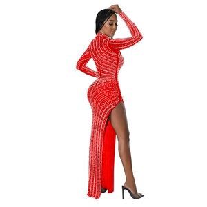 Detail of red mesh dress with vertical rhinestones and elegant high side slit design