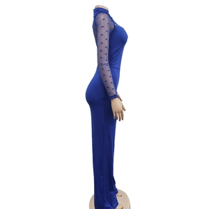 Detail view of royal blue jumpsuit with polka dot mesh sleeves and high collar design