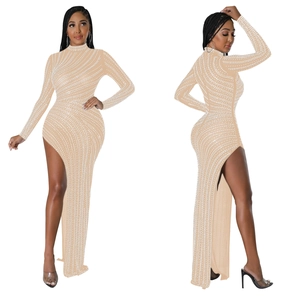 Detail of beige mesh evening dress with wave pearl embroidery and high side slit