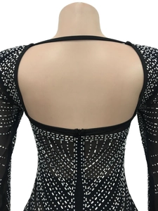 Détail d'une robe en maille dos nu ornée de strass argentés brillants et d'un zip à l'arrière