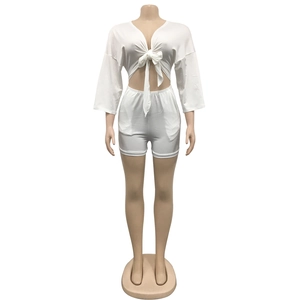 Front view of a white two-piece lounge set with tie-front crop top and high-waisted shorts