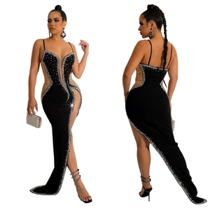 Detail of black rhinestone evening dress with high slit and sheer mesh paneling