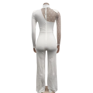 Detail of white jumpsuit featuring sheer polka dot mesh patchwork on the shoulder and back