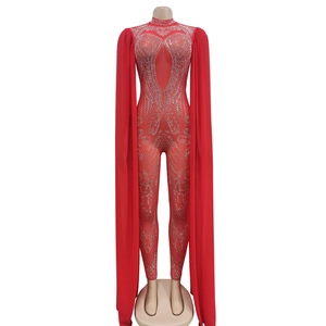 Detail view of red sheer mesh jumpsuit with rhinestones and long floor-length cape sleeves