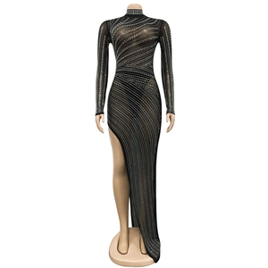 Detail of sheer black mesh dress with radiant silver rhinestones and a high side slit
