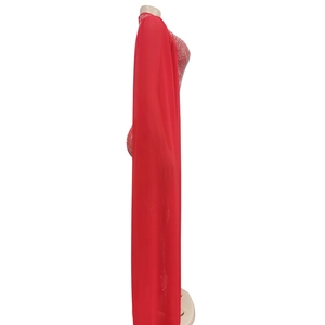 Detail of red mesh jumpsuit featuring sparkling rhinestones and elegant sheer fabric texture