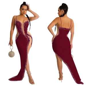 Detailed view of burgundy rhinestone evening dress with sheer mesh and high slit