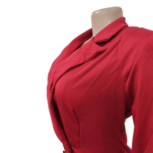 Detailed close-up of vibrant red blazer lapel with high-quality textile texture