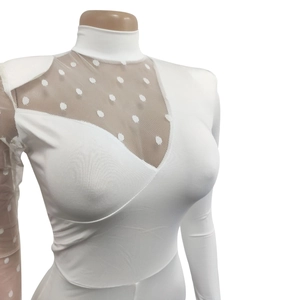 Detail of white high-neck bodysuit featuring dot mesh V-shaped patchwork and ribbed fabric