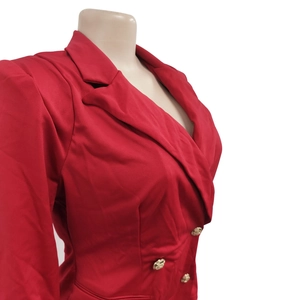 Detail of red slim fit blazer showing notched lapels and gold embossed metal buttons