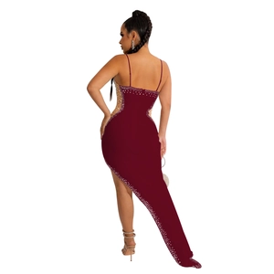 Detail view of burgundy sequined dress with asymmetric hemline and rhinestone trim back