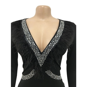 Detail of V-neck jumpsuit with black feathers and geometric silver rhinestone patterns
