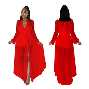 Detail of red sheer mesh long sleeve jumpsuit featuring diamond texture and waist tie