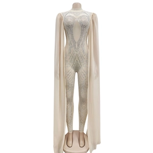 Detail of champagne jumpsuit with rhinestones and long sheer mesh cape sleeves