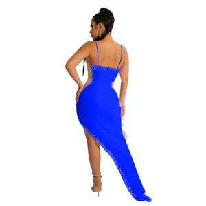 Detail of royal blue sleeveless dress featuring rhinestones and asymmetrical train