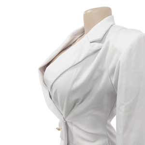 Detailed side view of a white women's blazer featuring a golden button and sharp lapels