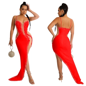 Detail of red rhinestone dress with V-neck, sheer mesh panels and high side slit
