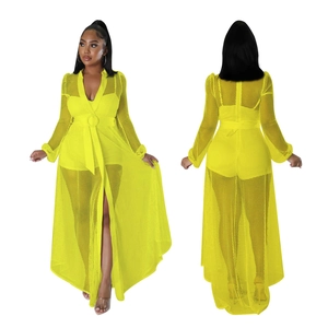 Detail view of neon yellow mesh jumpsuit showing long sleeves and adjustable waist buckle