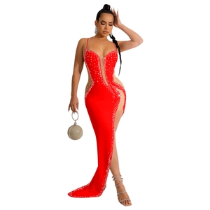 Close-up of red evening gown featuring rhinestone embellishments and mesh patchwork detail