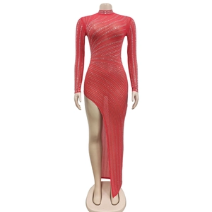 Detail of red mesh long sleeve dress with sparkling silver rhinestones and high slit
