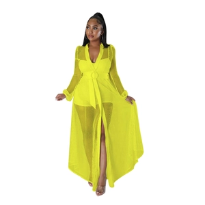 Detail of bright yellow long sleeve mesh cover-up with round buckle belt and high slit hem