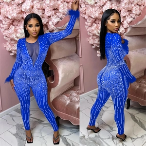 Women's deep blue V-neck mesh jumpsuit with silver rhinestones and feather cuffs