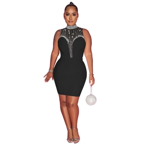 Détail d'une robe bandage noire sans manches avec des strass argentés brillants au décolleté