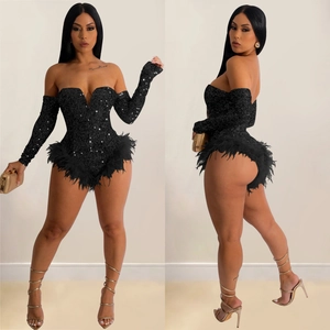 Detail of black sequin romper with off-shoulder sleeves and feather hem for party wear