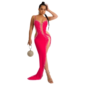 Detail of hot pink V-neck evening gown featuring silver rhinestones and high slit