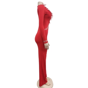 Detailed view of red catsuit with feather neckline and sequined wave patterns