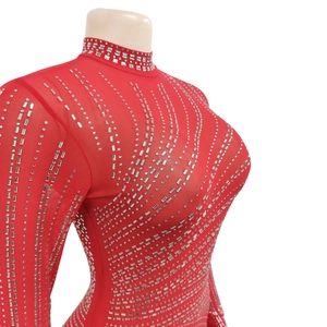 Close-up detail of red mesh bodycon dress with sparkling silver rhinestone patterns