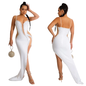 Detailed view of white rhinestone maxi dress featuring sheer mesh cutouts and high slit