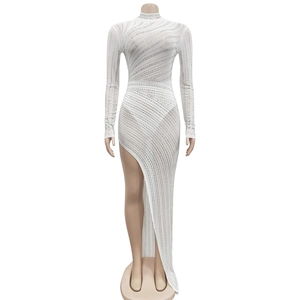 Detail of white mesh dress featuring shimmering silver rhinestones and a high side slit