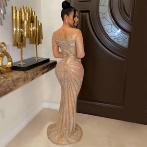 Detail of silver rhinestones on sheer mesh fabric of this elegant fishtail evening gown