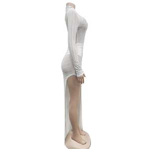 Detail of white mesh dress with vertical silver rhinestones and high side slit