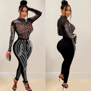 Women's black mesh jumpsuit with long sleeves and sparkling silver rhinestone patterns