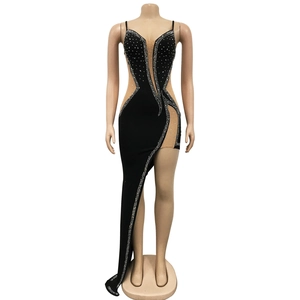 Close-up of asymmetrical black evening dress with rhinestones and mesh V-neckline