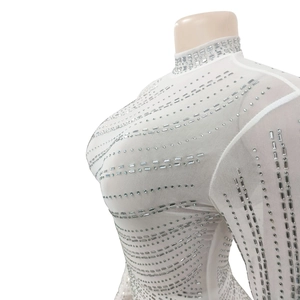 Detail of white mesh dress with rectangular rhinestones and sparkling sequins