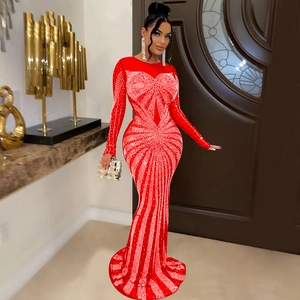 Detail of red mesh evening gown with sparkling rhinestones and elegant long sleeves