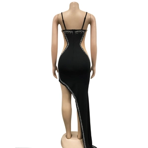 Detail of black rhinestone long dress showing open back design and asymmetric sequin hemline