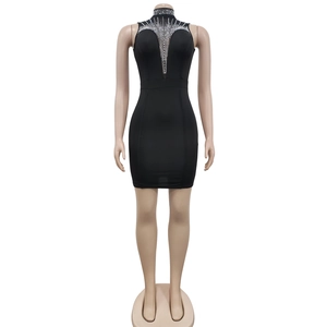 Vue détaillée des ornements en strass sur une robe noire en mesh à col montant