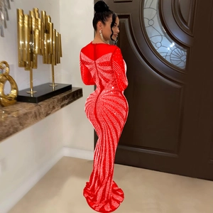 Detail of red floor-length evening gown featuring shimmering rhinestones and mesh texture