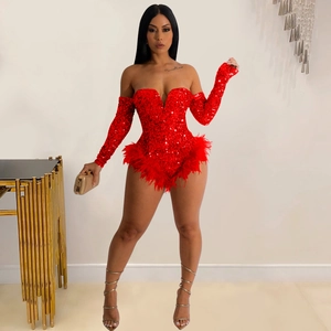 Detail of red sequined romper featuring fluffy feather hem and matching long sleeve sleeves