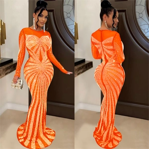 Detail of orange mesh gown with shimmering rhinestones and fishtail silhouette