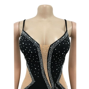 Close-up of elegant black evening dress featuring silver rhinestones and mesh V-neckline